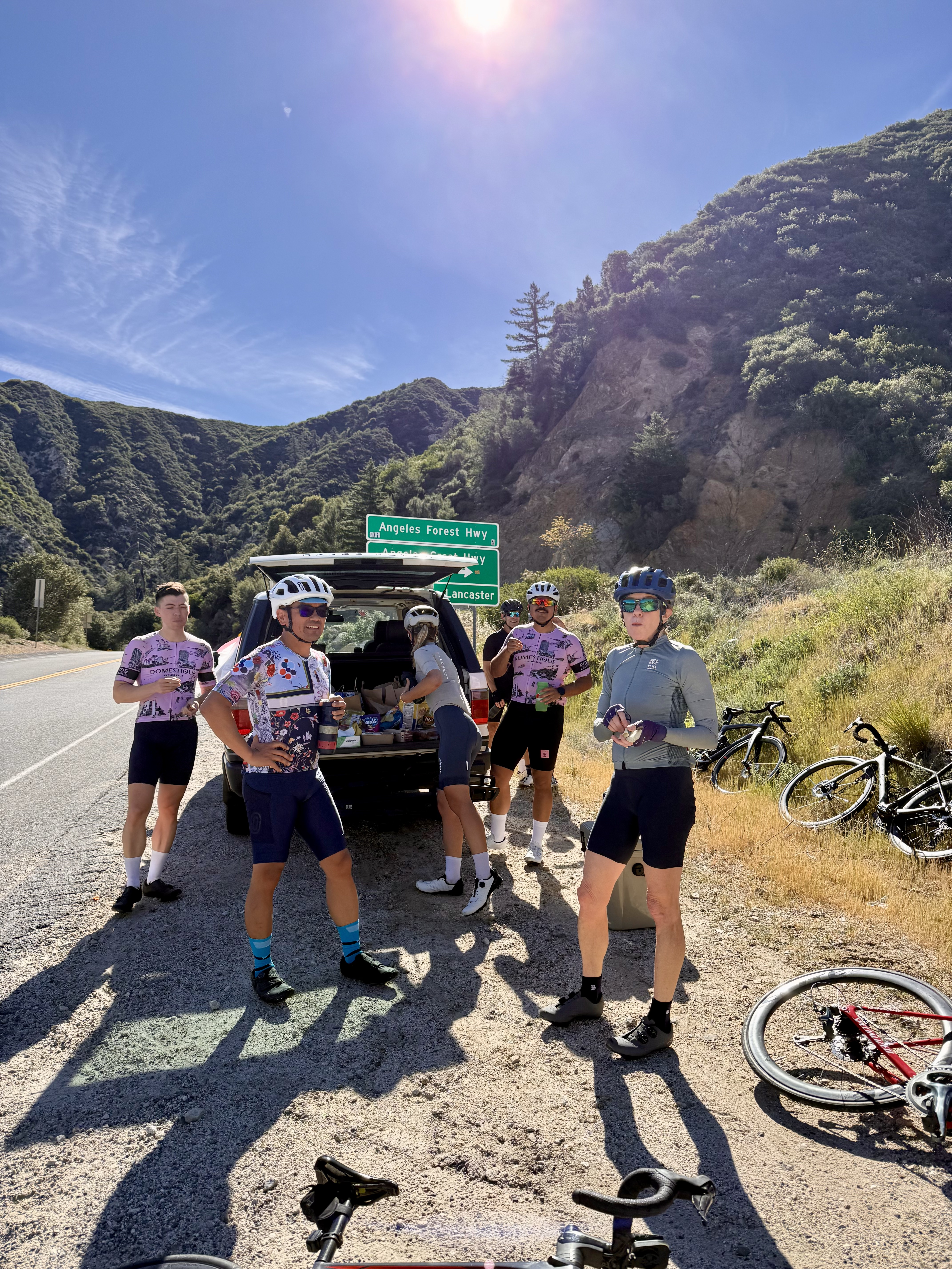 DCC riders gathered at a SAG vehicle on Angeles Forest Highway during a regroup