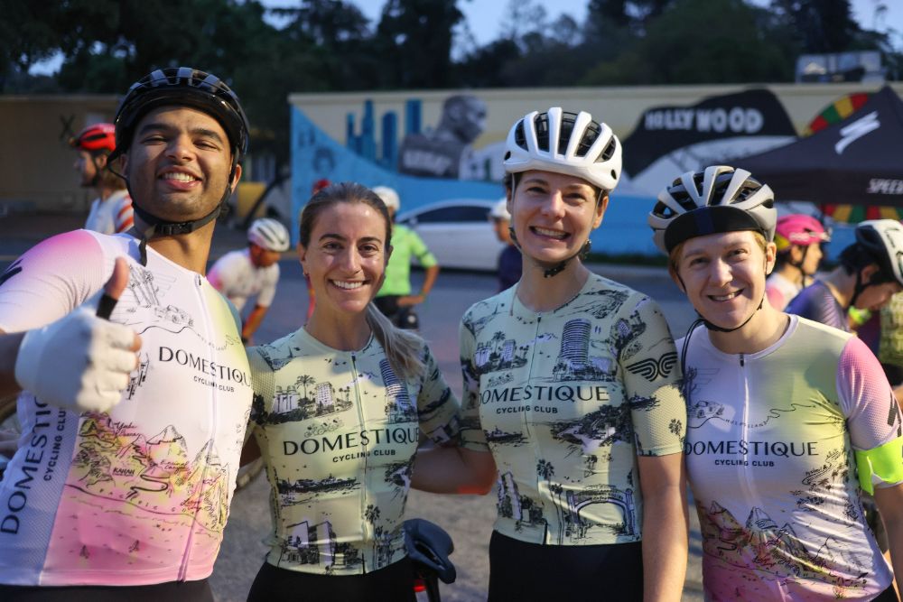 Four Domestique riders smiling before the start