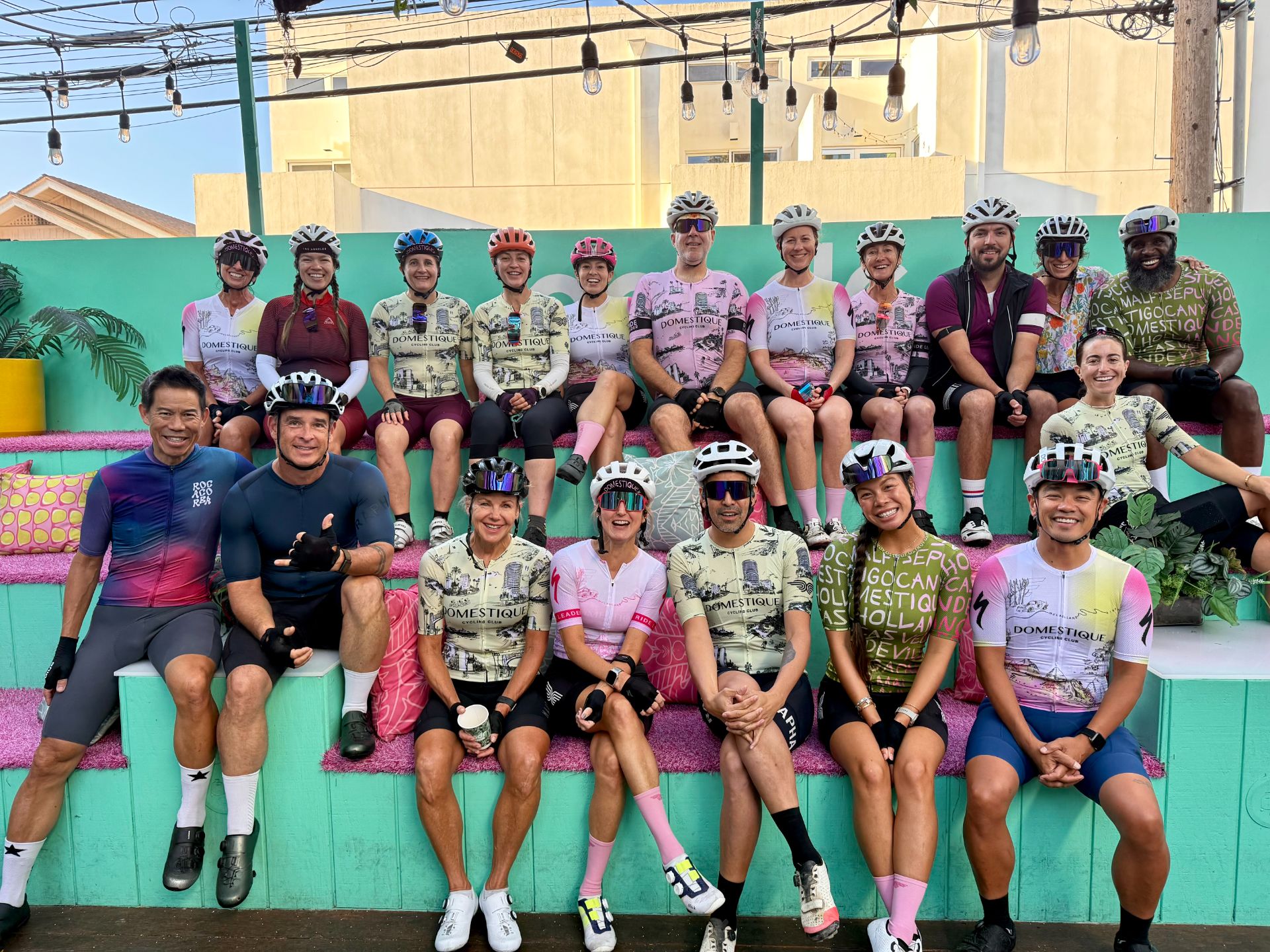 DCC members in club kit seated on the clubhouse bleachers