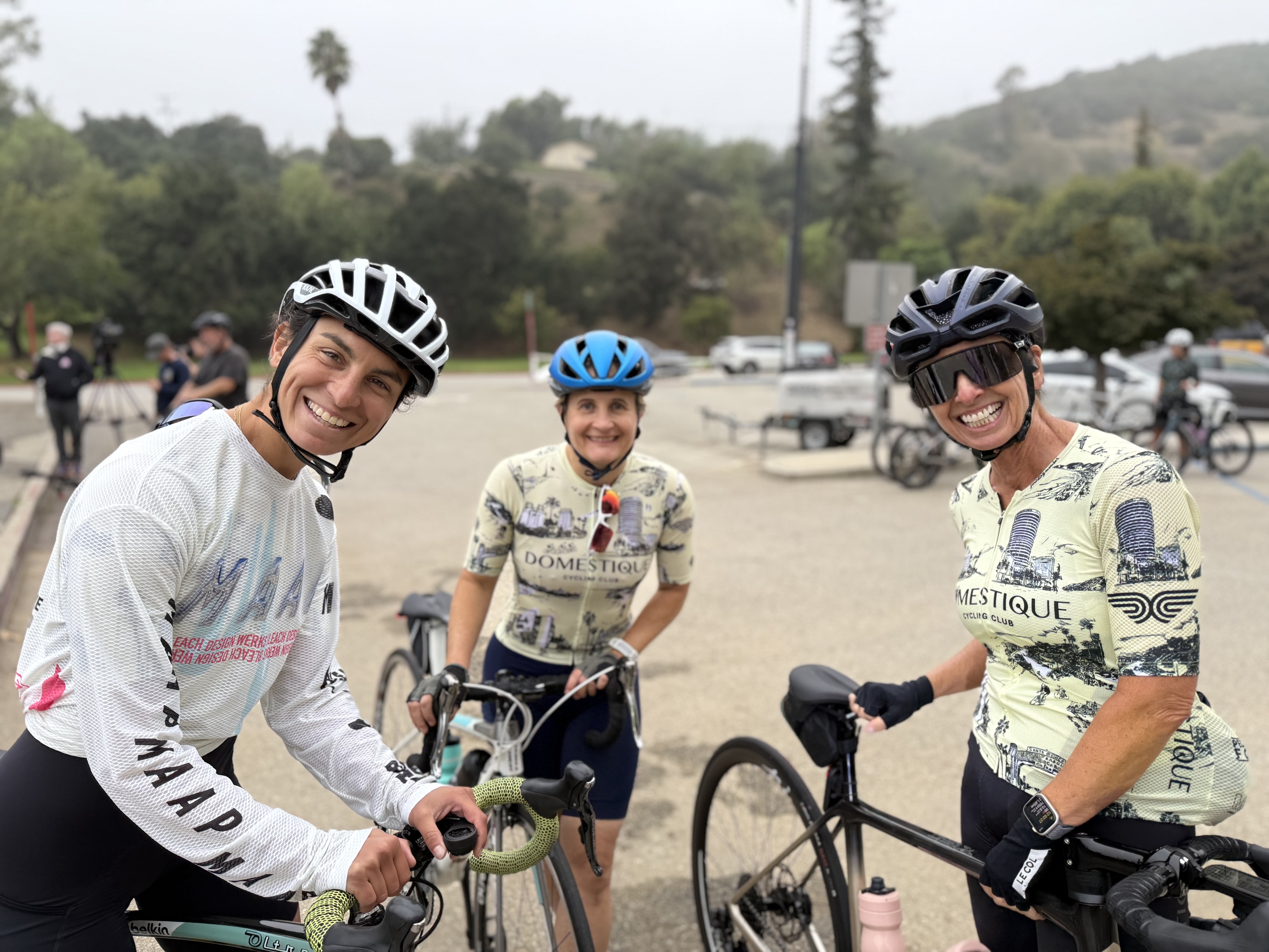 Three smiling DCC members on their bikes at a ride rollout