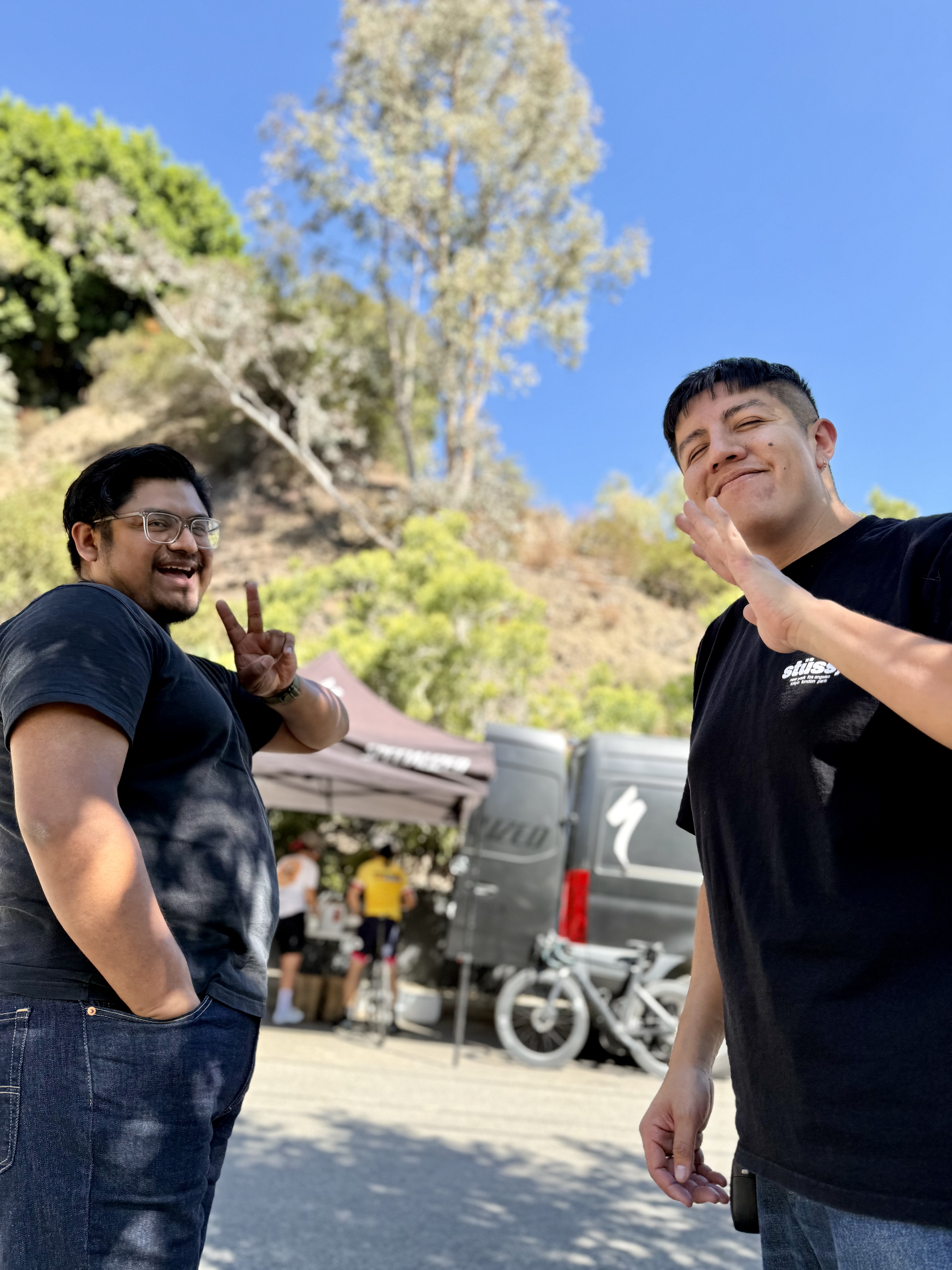 Two DCC members throwing peace signs at the Specialized Santa Monica SAG tent